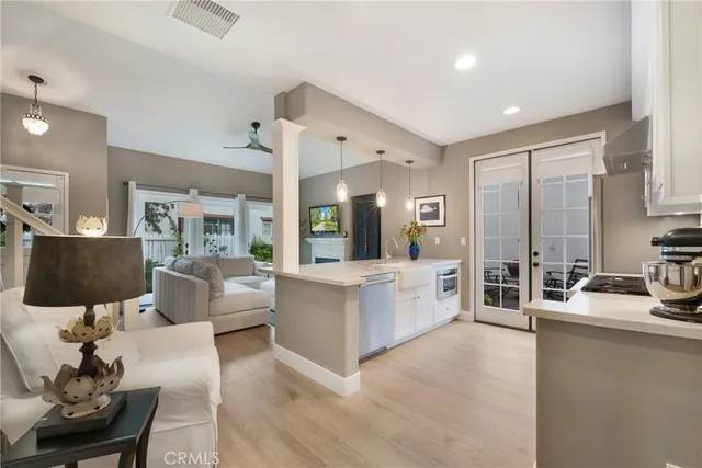 a living room with furniture and a painting on the wall