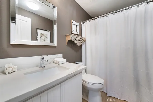 a bathroom with a shower sink and mirror
