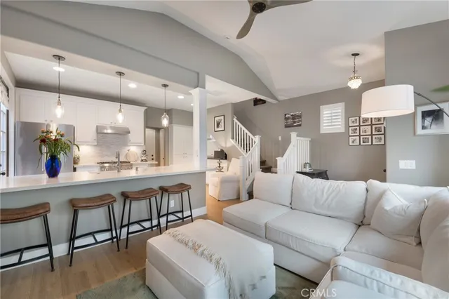 a living room with furniture and a potted plant