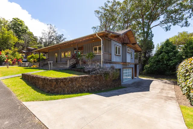 a front view of a house with a yard fire pit and outdoor seating