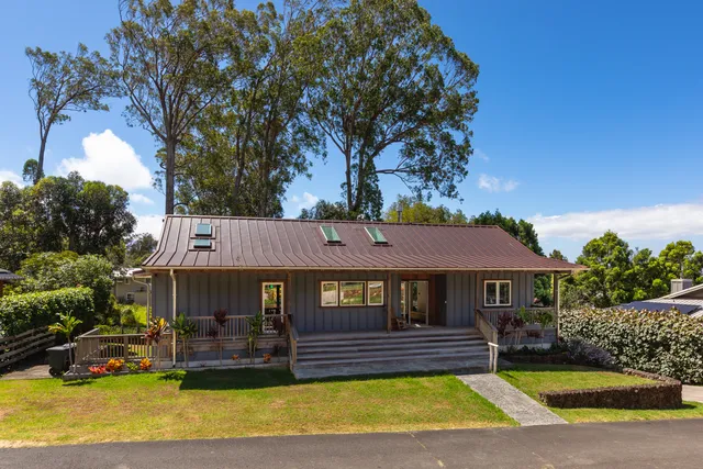 a view of a house with swimming pool and sitting area