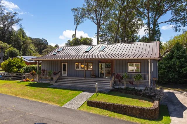 a view of a house with swimming pool and a yard