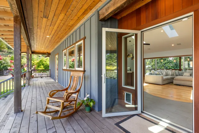 a view of a two chair in the balcony next to a yard