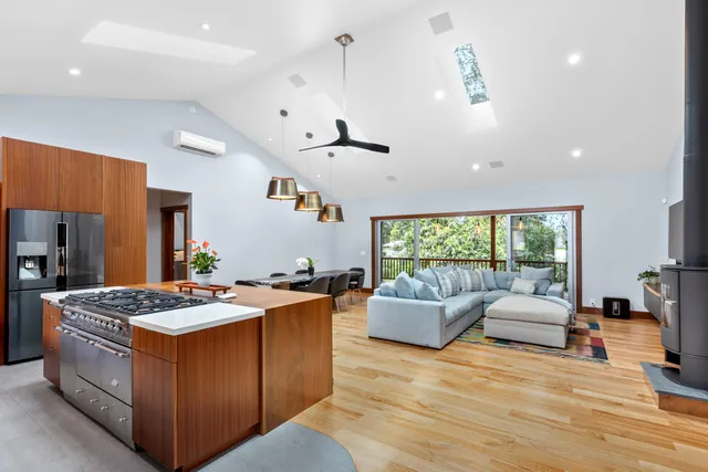 a open kitchen with stainless steel appliances granite countertop a stove and a refrigerator