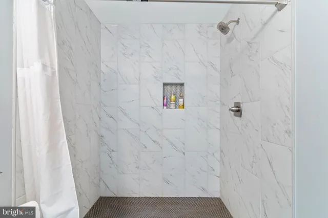 a bathroom with a sink toilet vanity and shower