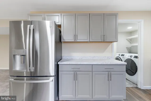 a kitchen with a refrigerator and cabinets
