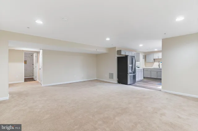 a view of an empty room with a cabinet