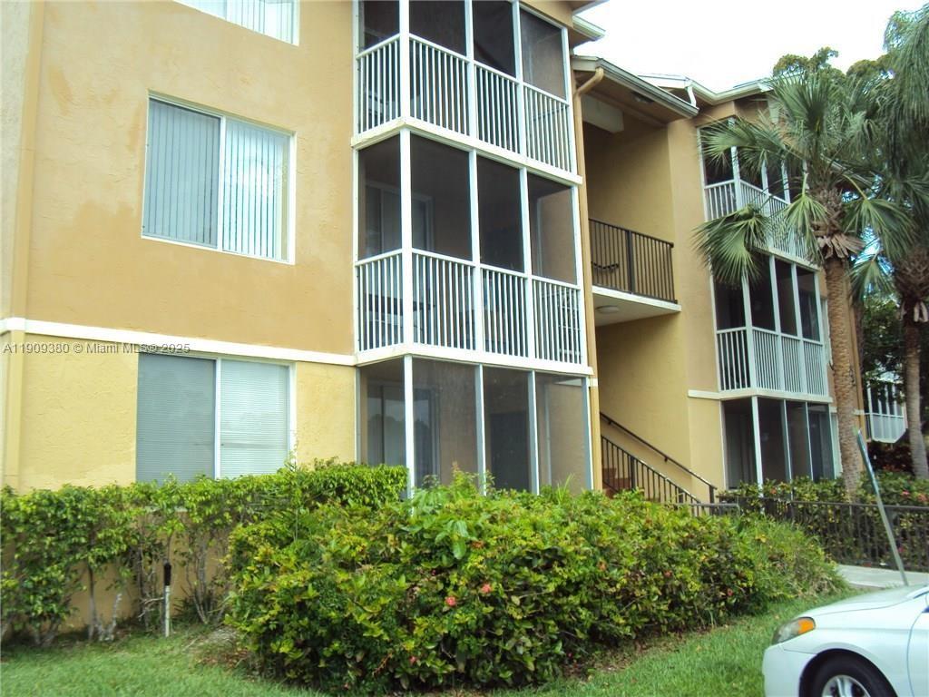 4055 West McNab Road, Unit H103 Pompano Beach, FL 33069 - Photo 1 of 14 a view of a house with a large window and yard