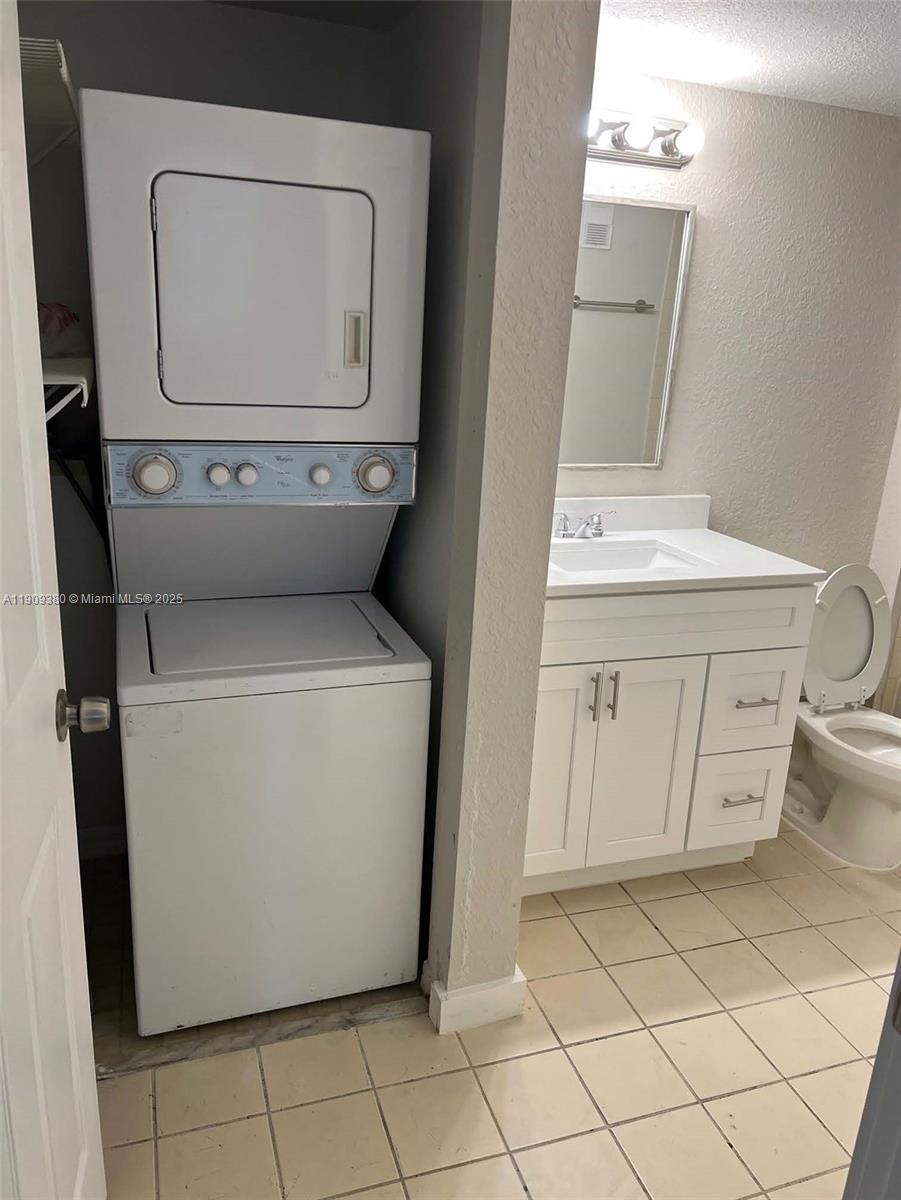 4055 West McNab Road, Unit H103 Pompano Beach, FL 33069 - Photo 12 of 14 a utility room with dryer and washer