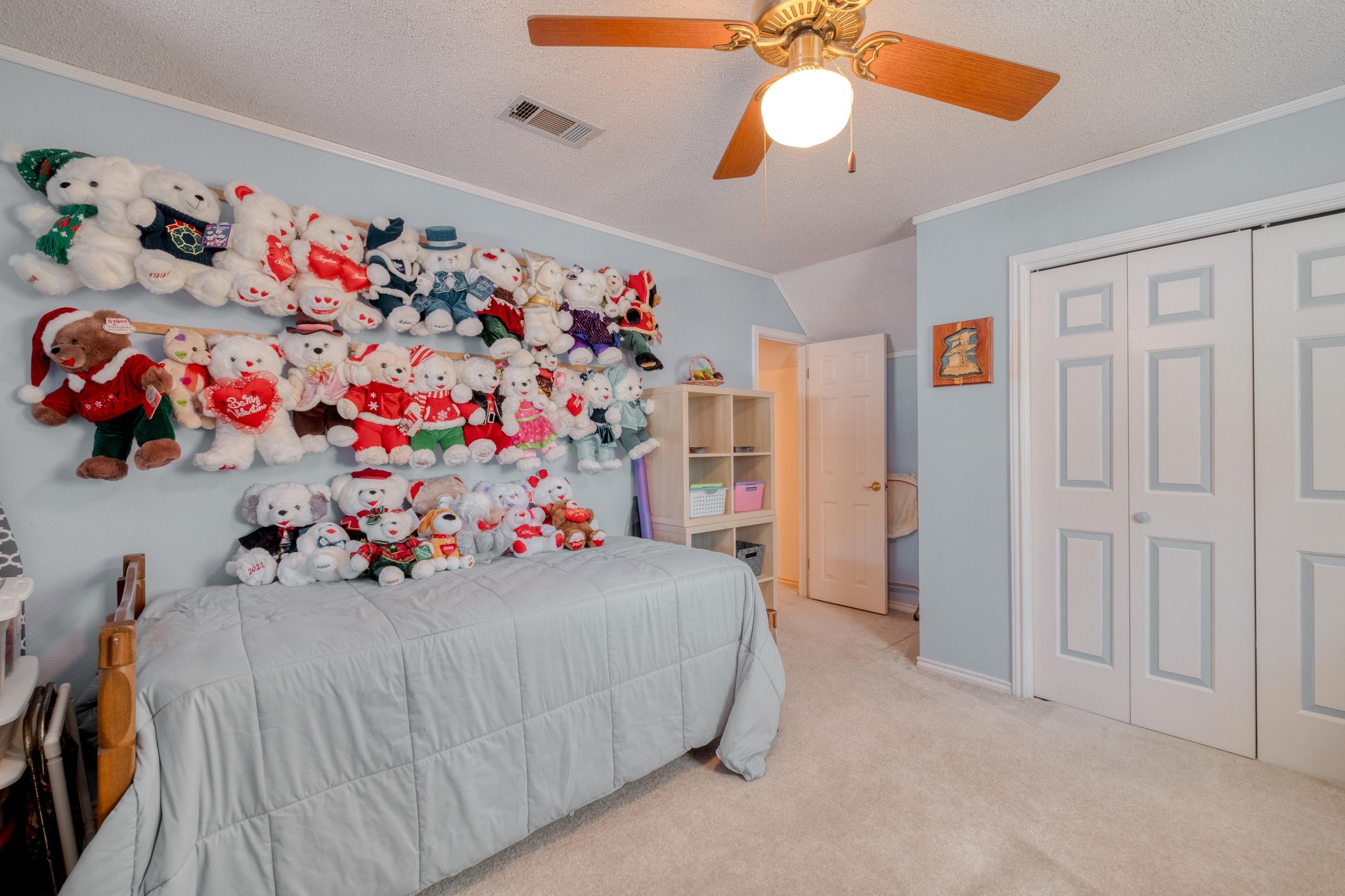 153 Pleasant Grove Road Elgin, TX 78621 - Photo 22 of 34 Bedroom featuring crown molding, vaulted ceiling, carpet flooring, a textured ceiling, and ceiling fan