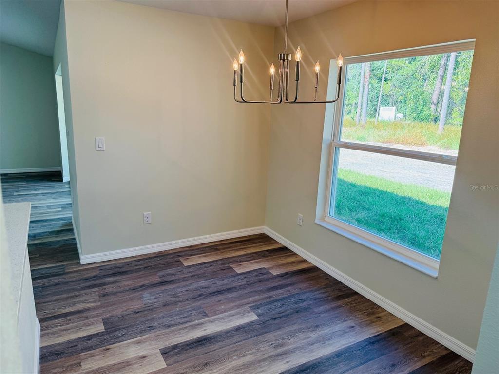 13465 Canyon Swallow Road Weeki Wachee, FL 34614 - Photo 11 of 22 a view of a room with wooden floor fan and window