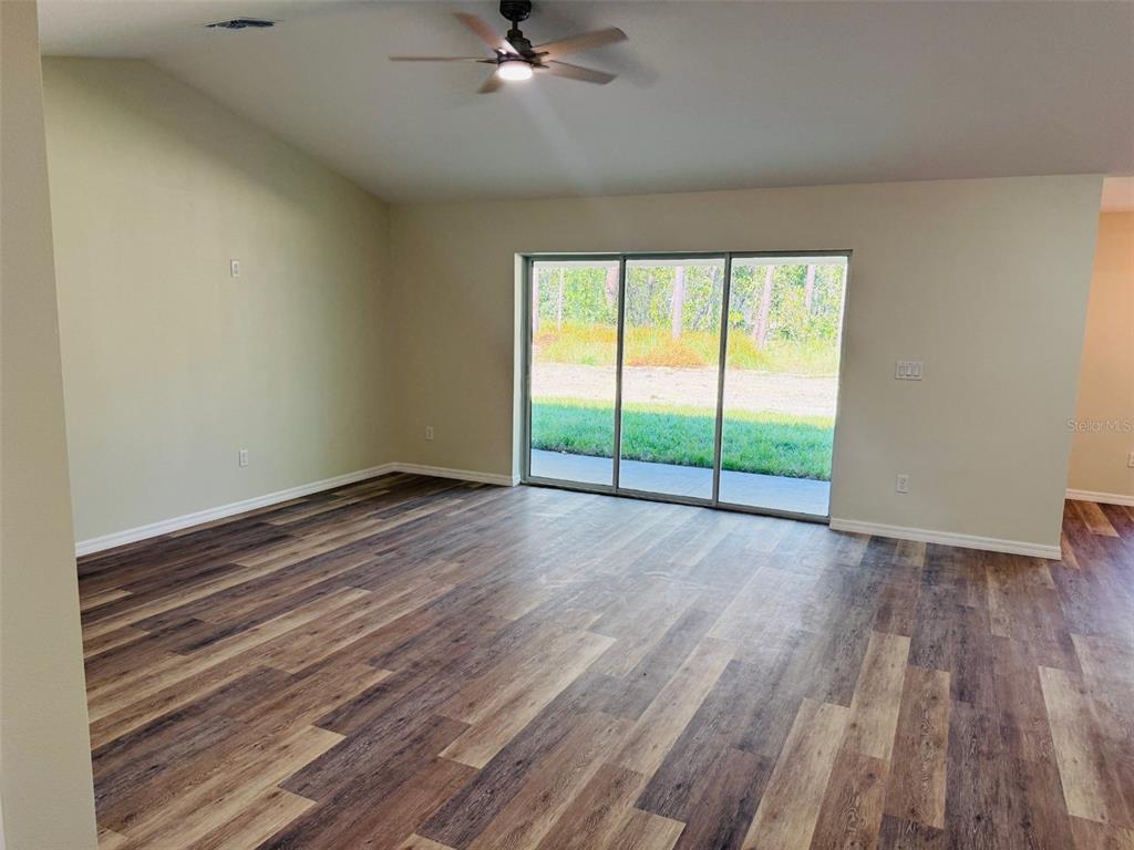 13465 Canyon Swallow Road Weeki Wachee, FL 34614 - Photo 12 of 22 wooden floor in an empty room with a window