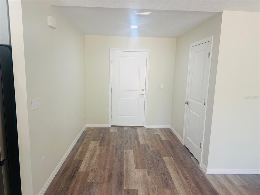 13465 Canyon Swallow Road Weeki Wachee, FL 34614 - Photo 13 of 22 a view of a hallway with wooden floor