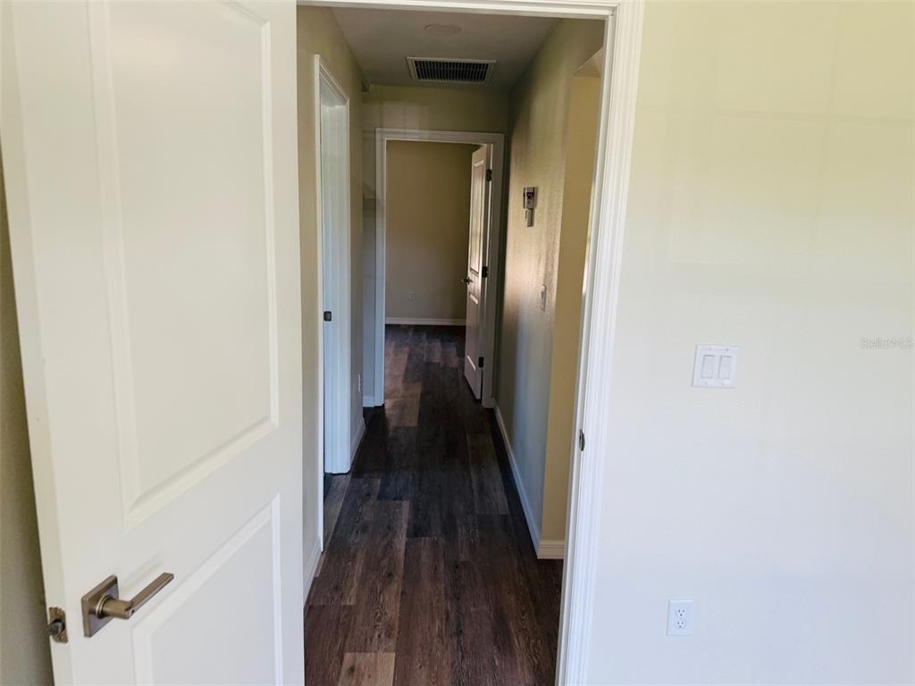 13465 Canyon Swallow Road Weeki Wachee, FL 34614 - Photo 15 of 22 a view of a hallway with a wooden floor