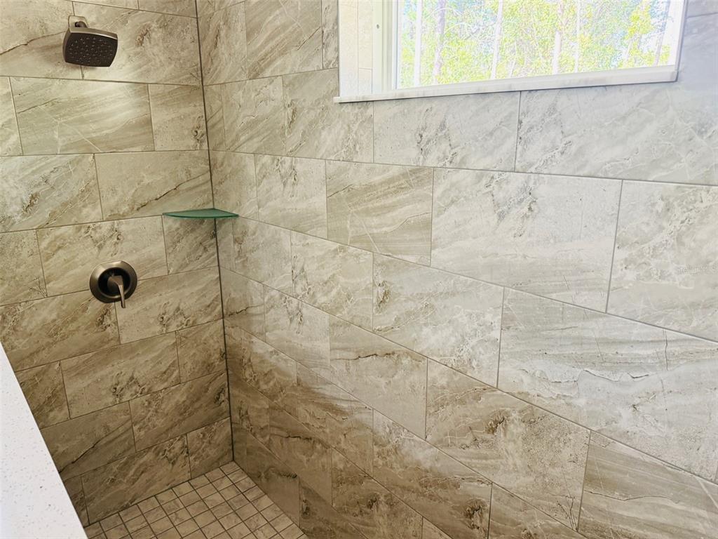 13465 Canyon Swallow Road Weeki Wachee, FL 34614 - Photo 19 of 22 a bathroom with a shower
