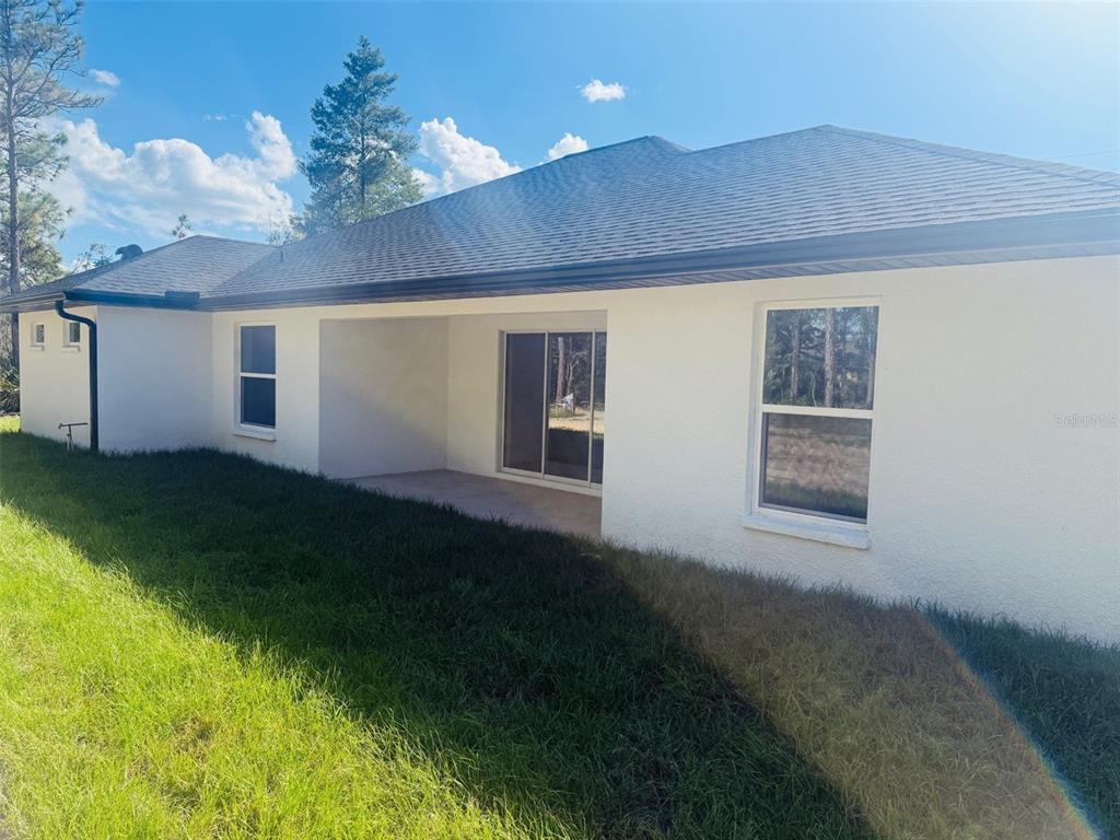 13465 Canyon Swallow Road Weeki Wachee, FL 34614 - Photo 2 of 22 a view of a house with a yard
