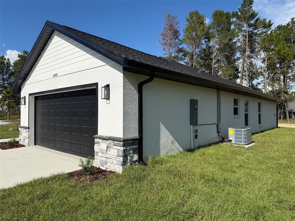 13465 Canyon Swallow Road Weeki Wachee, FL 34614 - Photo 3 of 22 a front view of a house with a yard
