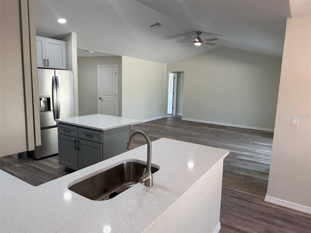 13465 Canyon Swallow Road Weeki Wachee, FL 34614 - Photo 7 of 22 a large kitchen with stainless steel appliances a large counter top