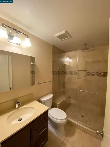 a bathroom with a sink mirror toilet and shower