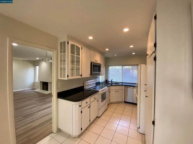 a kitchen with stainless steel appliances granite countertop a sink and cabinets