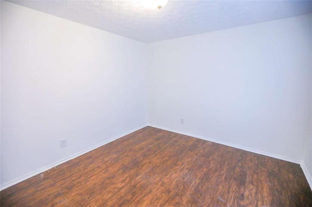 1967 Singer Way Lithonia, GA 30058 - Photo 17 of 27 a view of empty room with wooden floor