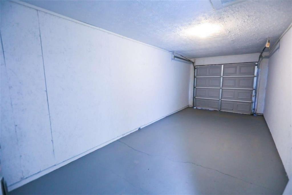 1967 Singer Way Lithonia, GA 30058 - Photo 7 of 27 an empty room with a fireplace and wooden floor