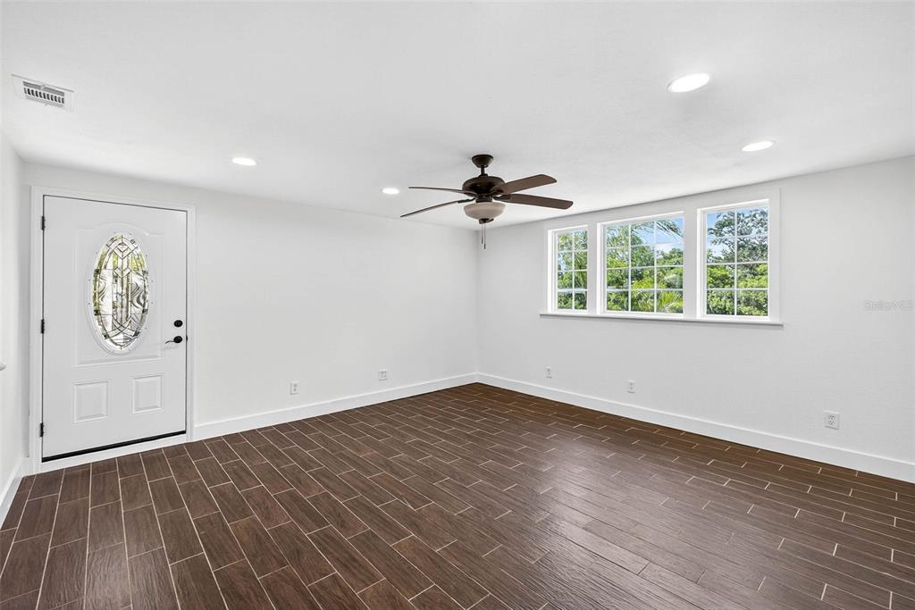 3225 West Shell Point Road Ruskin, FL 33570 - Photo 16 of 57 a view of an empty room with a window and wooden floor