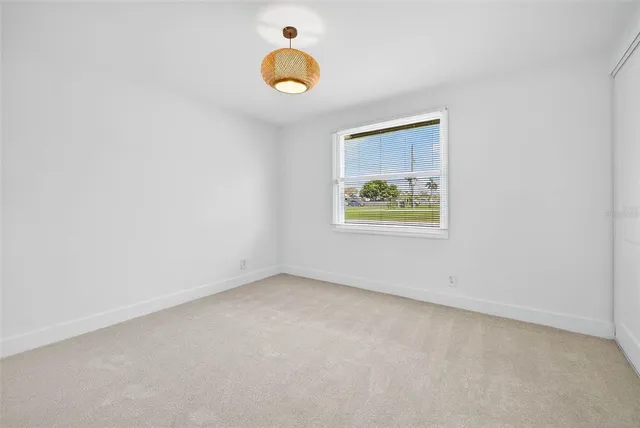 an empty room with a ceiling fan
