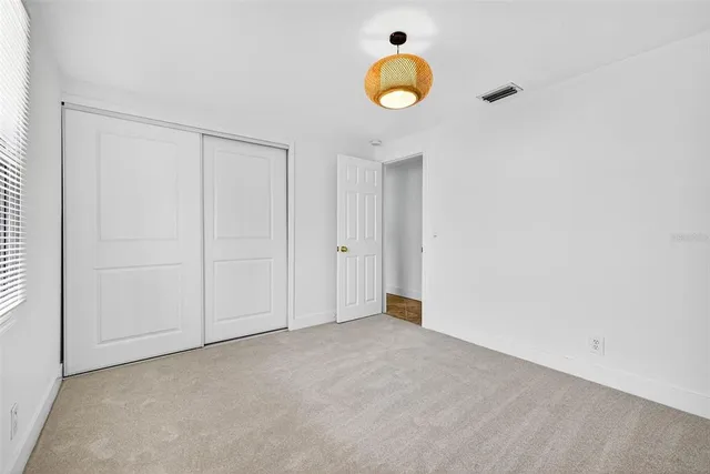a bathroom with a granite countertop sink toilet and a mirror