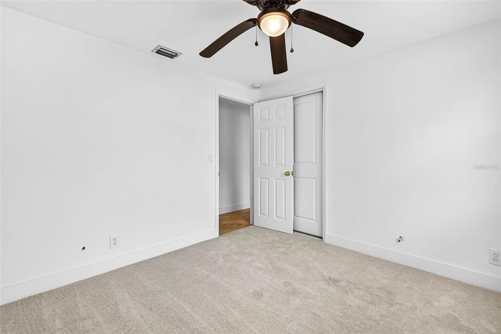 3225 West Shell Point Road Ruskin, FL 33570 - Photo 22 of 57 an empty room with a ceiling fan