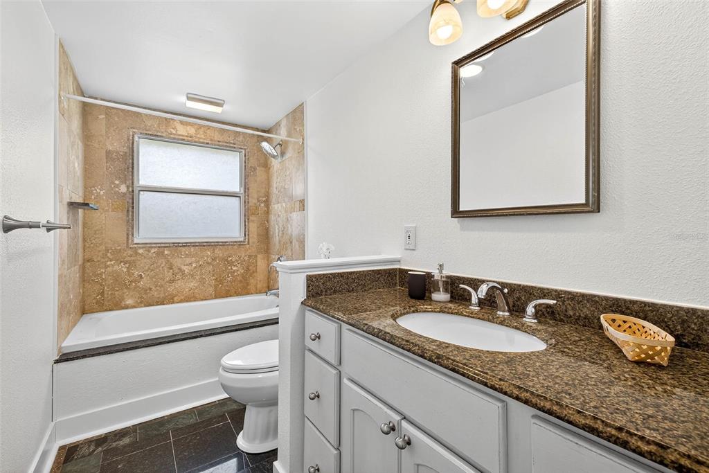 3225 West Shell Point Road Ruskin, FL 33570 - Photo 23 of 57 a bathroom with a granite countertop sink toilet and a mirror