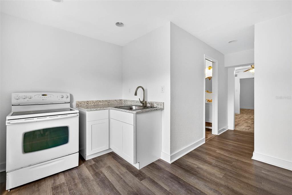 3225 West Shell Point Road Ruskin, FL 33570 - Photo 49 of 57 a kitchen with a stove and white cabinets