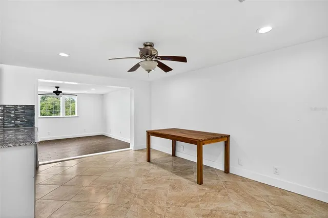 a view of kitchen with kitchen island and stainless steel appliances