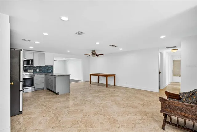 a kitchen with sink a stove and cabinets
