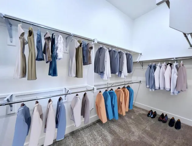 a view of walk in closet with clothes and shoes