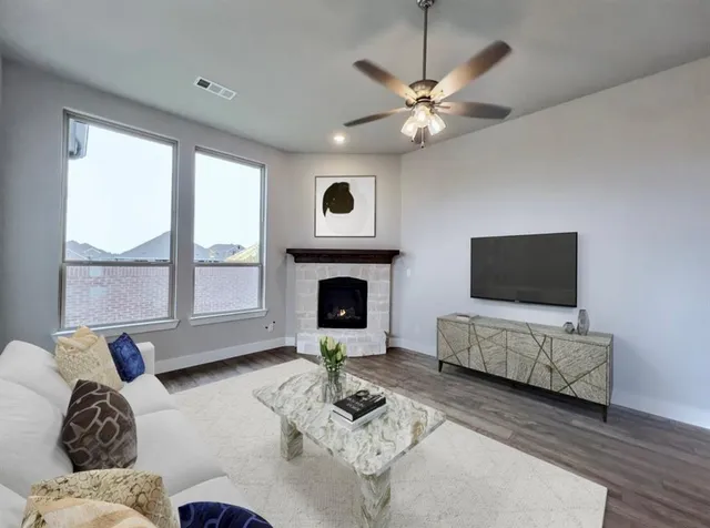 a living room with furniture fireplace and flat screen tv