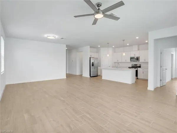 a view of a kitchen with a stove cabinets and a ceiling fan