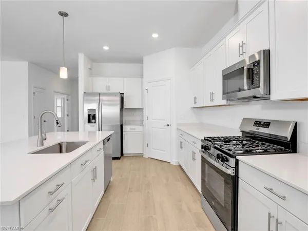 a kitchen with stainless steel appliances a sink stove and refrigerator