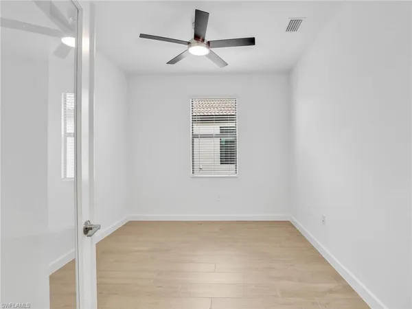 a view of empty room with ceiling fan
