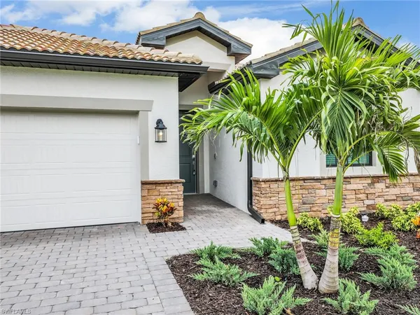 a potted plant is sitting in front of a house