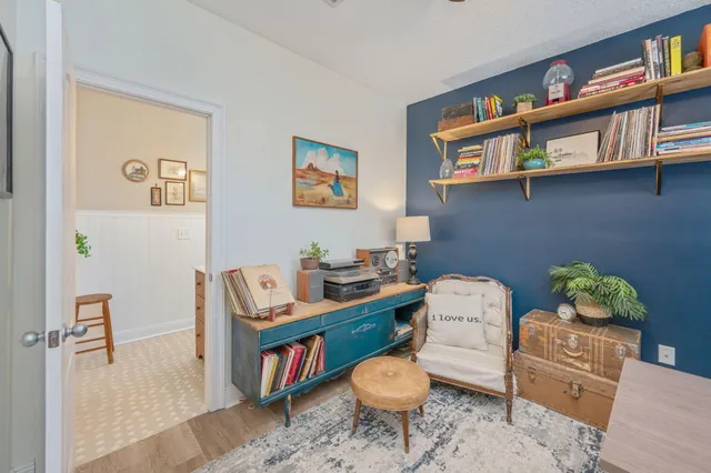 a living room with furniture and a book shelf