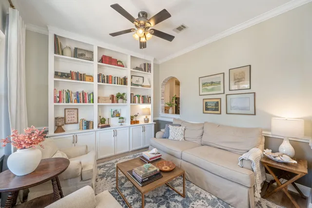 a living room with furniture and a bookshelf