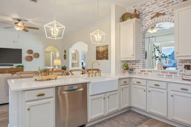 a kitchen with cabinets appliances and a sink