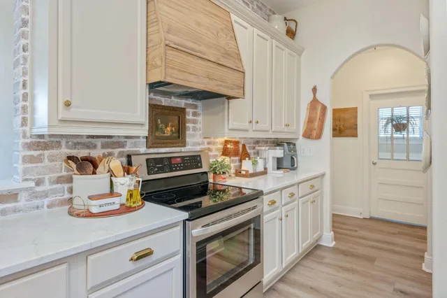 a kitchen with a refrigerator and cabinets