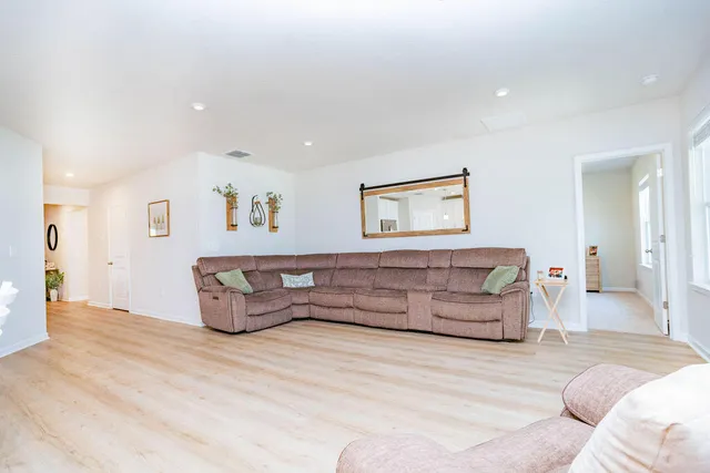 a view of a kitchen with wooden floor and electronic appliances