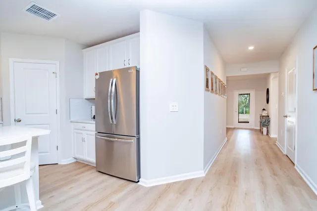 a bed sitting in a spacious bedroom next to a window