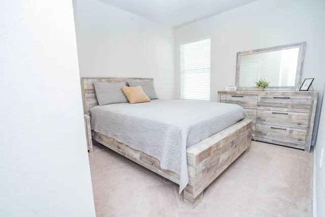 a bedroom with a bed and a window