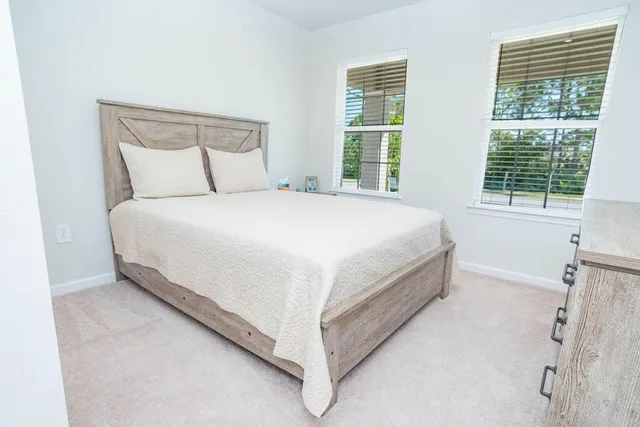 a bedroom with a bed and a mirror