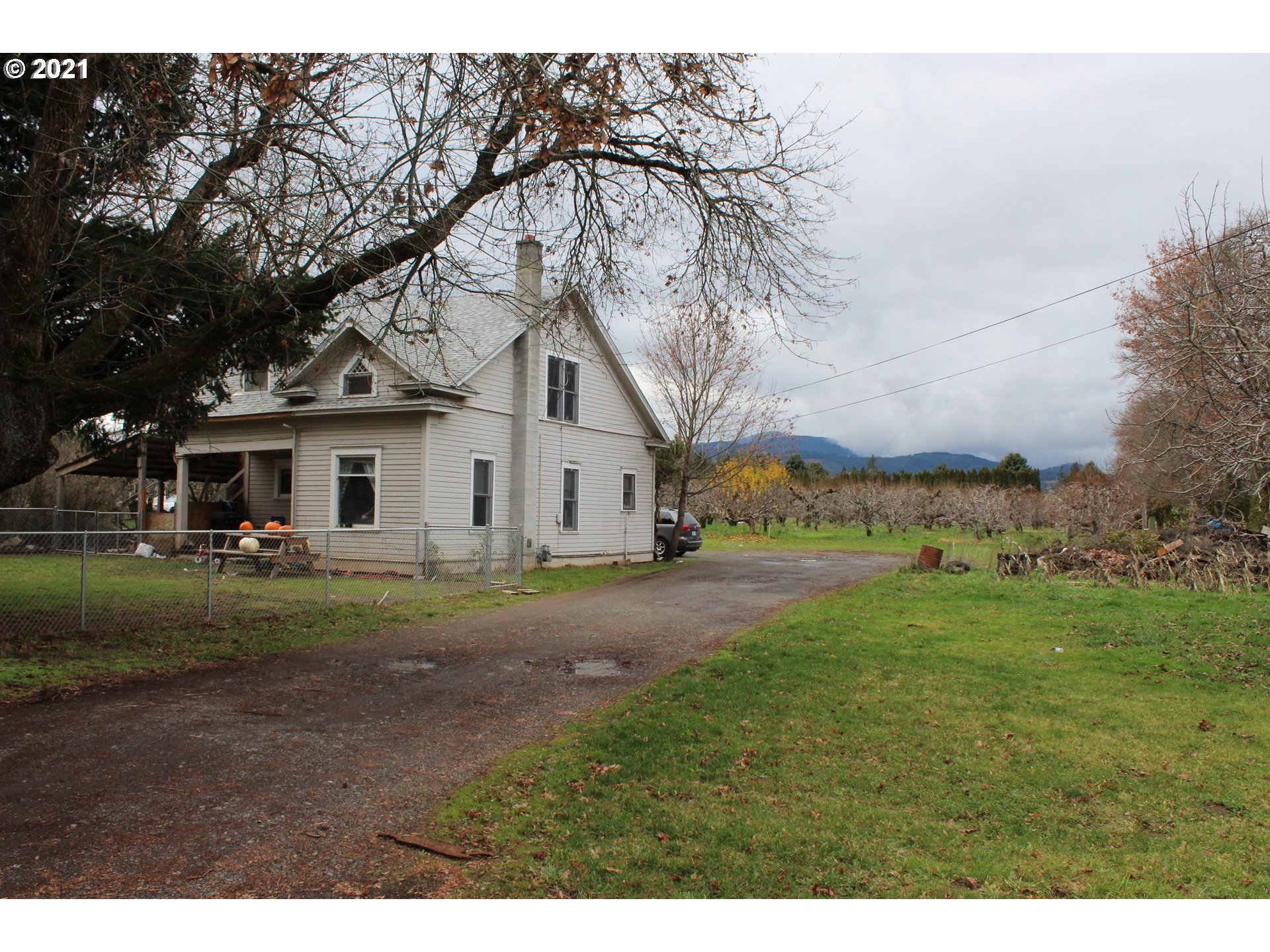 1000 Tucker Road Hood River, OR 97031 - Photo 1 of 1 a view of a yard in front of a house with a large tree