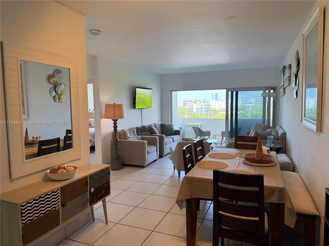 a room with furniture a flat screen tv and a window